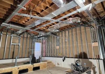 A room with a metal ceiling and pipes being installed.