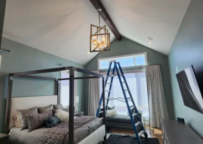 A room with a bed and a ladder in it.