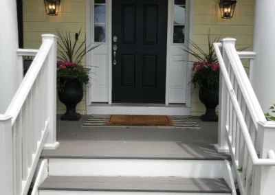 A house with a white front door and black steps.