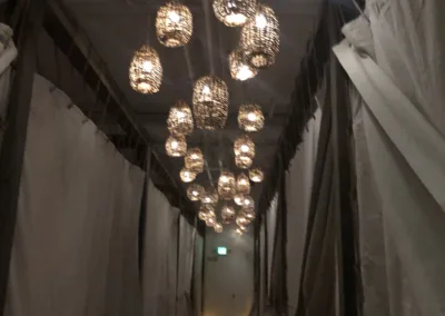 A hallway with a lot of lights hanging from the ceiling.