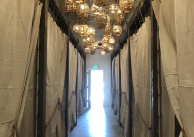 A hallway with several hanging lanterns in it.